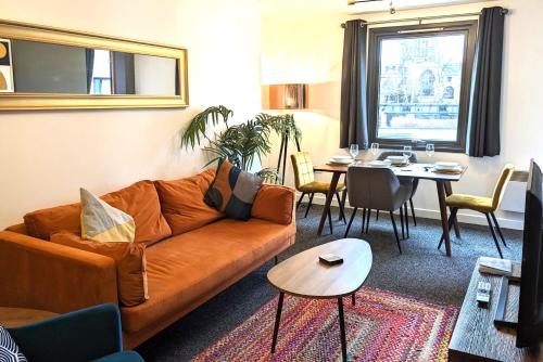 a living room with a couch and a table at Gorgeous Modernised City Centre Apartment in Coventry