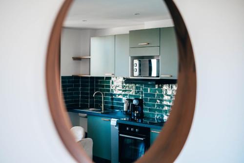 a kitchen with blue cabinets and a sink at Vélodrome 6 couchages avec clim in Marseille