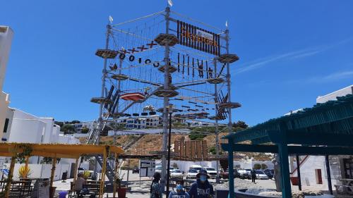 a large metal clock tower in a parking lot at Smartie Box in Langebaan
