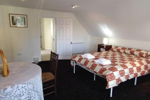 a hotel room with a bed and a table and a room at Lyndale House - North Norwich suburbs in Norwich