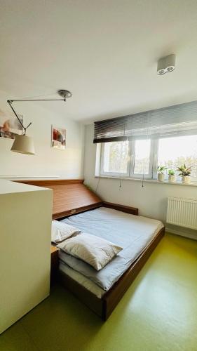 a bedroom with two beds and a window at Smart Apartment Warsaw in Warsaw
