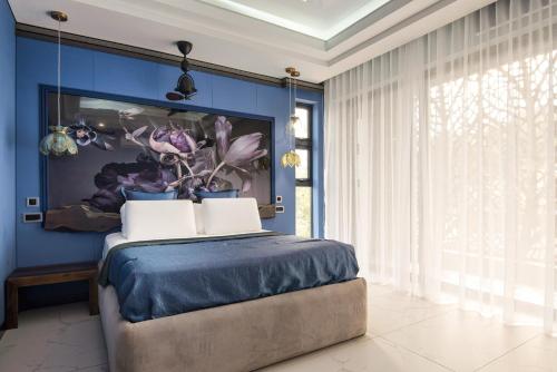 a bedroom with blue walls and a bed with two pillows at FlamencoAccommodation in Ballito
