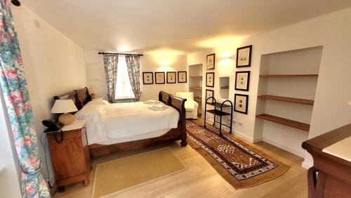 a bedroom with a bed and a window and shelves at Castello di Vezio in the Village in Varenna