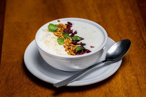 a bowl of rice on a plate with a spoon at Hotel Villa Mercedes Palenque in Palenque