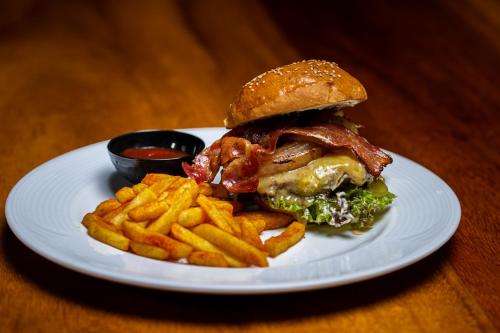 a sandwich and french fries on a white plate at Hotel Villa Mercedes Palenque in Palenque