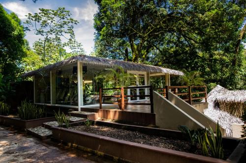 a glass house in the middle of a garden at Hotel Villa Mercedes Palenque in Palenque