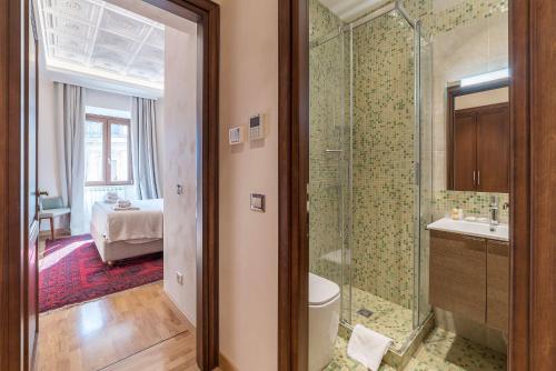 uma casa de banho com um chuveiro, um WC e um lavatório. em 900 Apartments Veneto & Pinciana em Roma