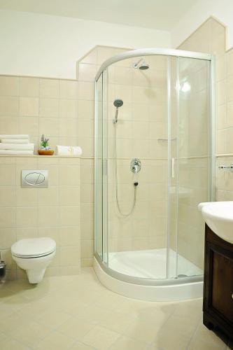 a bathroom with a shower and a toilet and a sink at Szekszárd Szálló in Szekszárd