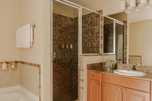 a bathroom with a shower and a sink at The Point Universal by Edge near Epic in Orlando