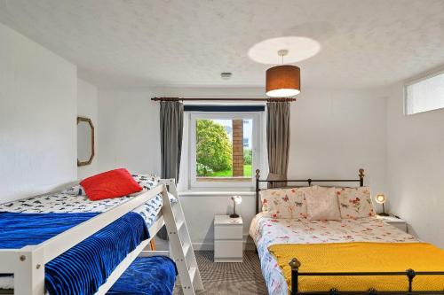 a bedroom with two bunk beds and a window at Finest Retreats - Atherfield Apartments No 4 - Lawn Side in Paignton
