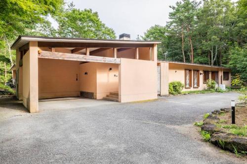 a house with a large garage in front of it at Private Villa J プライベートヴィラJ in Narusawa