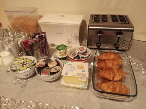 a table with a bunch of food on a counter at Ardenlea House Hotel B&b in Dyce
