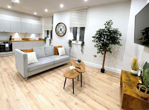 a living room with a couch and a table at Shrewsbury apartments by BEVOLVE - Free Parking in Shrewsbury