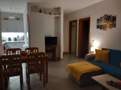 a living room with a couch and a table at Αγ Νικόλαος Karthaia in Elliniká
