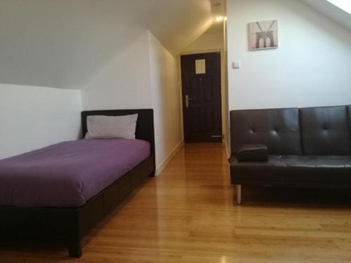 a bedroom with a couch and a bed and a couch at Ardenlea House Hotel B&b in Dyce