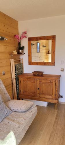 a room with a wooden dresser and a mirror at Appartement les 2 Alpes avec vue sur la muzelle in Vénosc
