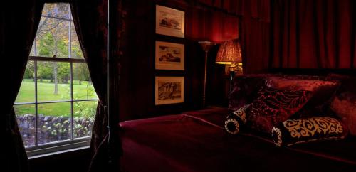 a bedroom with a bed and a window at Prestonfield House in Edinburgh