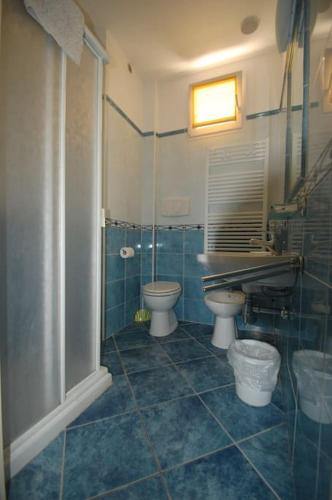 a bathroom with two toilets and a sink at Souvenir 6 in Gabicce Mare