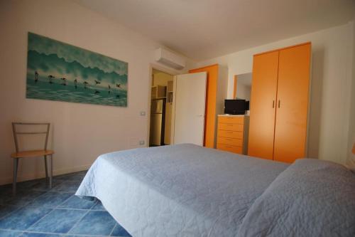 a bedroom with a bed and a chair in it at Souvenir 6 in Gabicce Mare