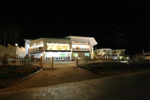 a building at night with a fence in front of it at Coron Hilltop View Resort in Coron