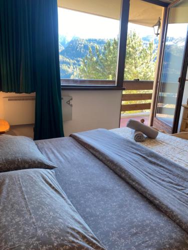 Säng eller sängar i ett rum på Encia's Home Dolomiti