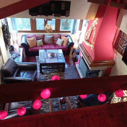 a living room with a couch and a table at CHALET LE BLANC in Arachova