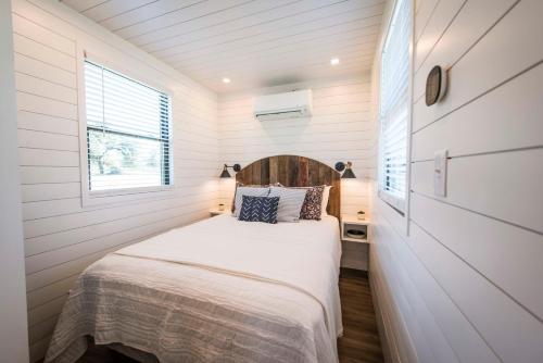 a bedroom in a tiny house with a bed at The Meadows Shipping Container Home in Bellmead