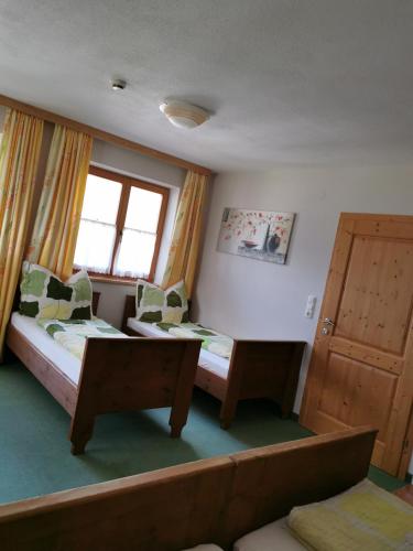 a bedroom with two beds and a window at Gästehaus Bonholz in Stummerberg
