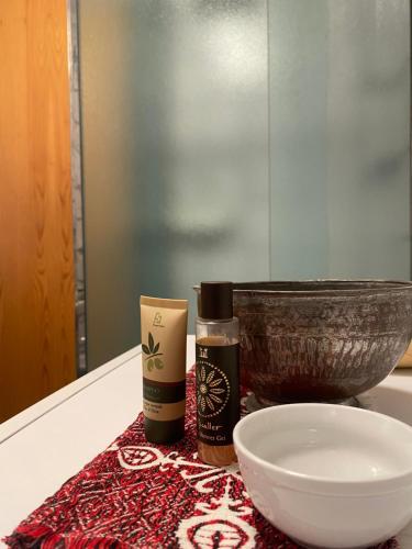 a counter top with a bowl and a bottle of oil at Encia's Home Dolomiti in Castello di Fiemme