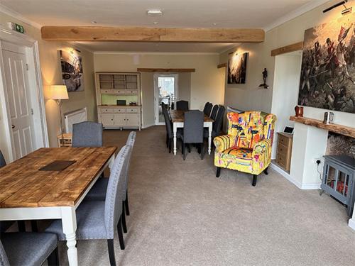 a living room with a table and a dining room at Forces Manor in Kincraig