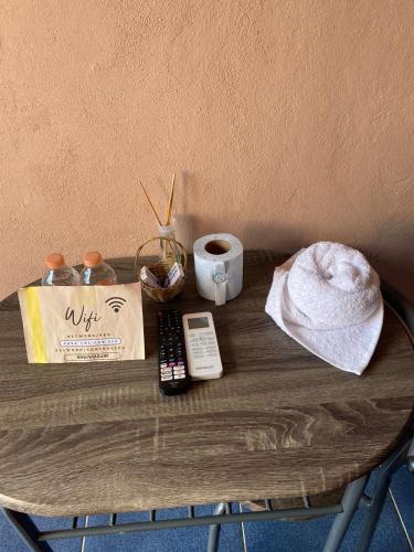 a table with a remote control and a cup of coffee at Casa Lol-cab Hostal in Valladolid