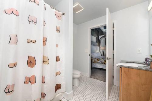 a bathroom with a shower curtain with shoes at Peters Cartridge Factory in Maineville