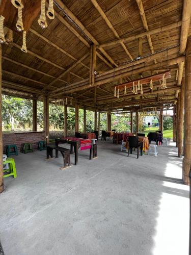 a large pavilion with tables and chairs in it at Finca Hostal La Esperanza in Quimbaya