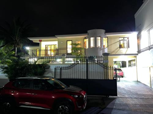 a car parked in front of a house at night at Villa Tameva in Flic-en-Flac