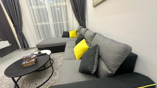 a living room with a couch and a table at Luxury 2 bedroom new brand in Ajman 