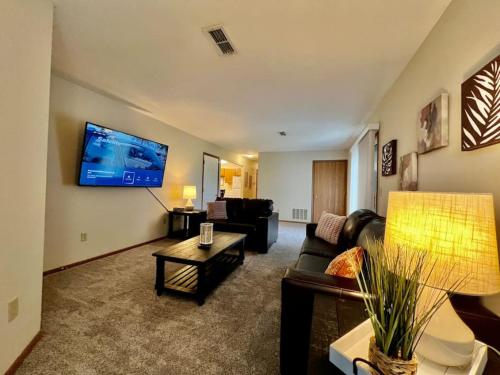 a living room with a couch and a tv on the wall at Cozy 2 Bedroom Paired Home in Middletown, OH in Middletown
