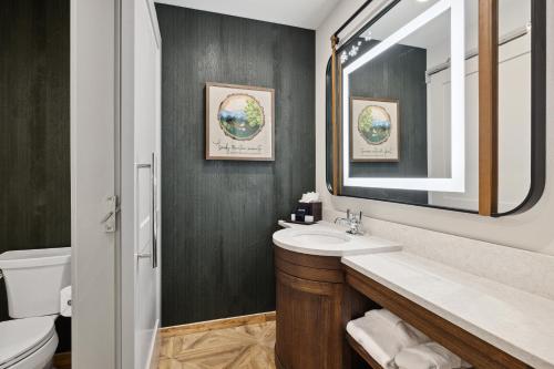 a bathroom with a sink and a mirror at Dollywood's HeartSong Lodge & Resort in Pigeon Forge