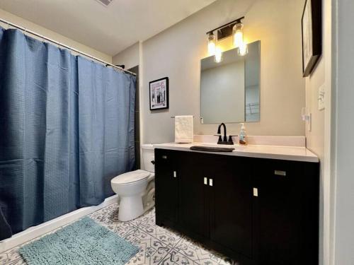 a bathroom with a sink and a toilet and a mirror at Quaint 4 Bedroom Ranch Home in Mason Ohio in Mason