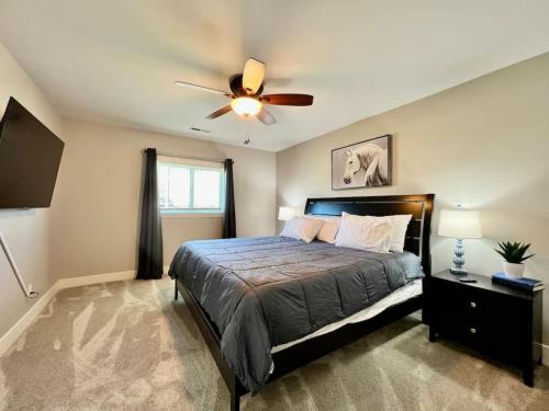 a bedroom with a bed and a ceiling fan at Quaint 4 Bedroom Ranch Home in Mason Ohio in Mason