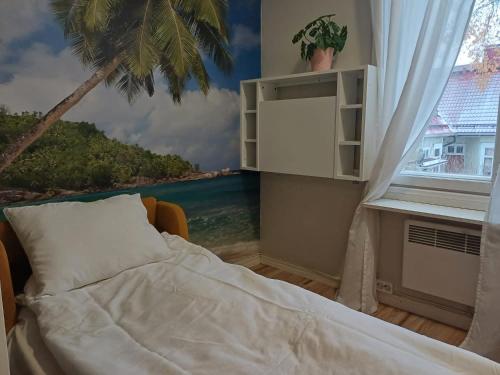 a bedroom with a window with a view of the ocean at Unique wooden house apartment with separate office room in Turku
