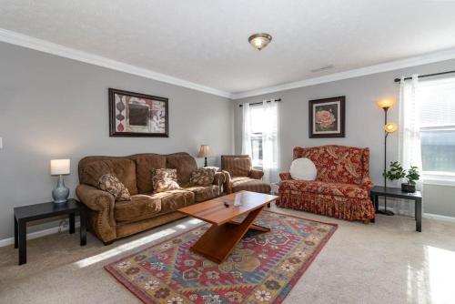 a living room with a couch and a chair at Relaxing home near Interstate in Monroe