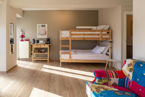 a room with two bunk beds and a couch at Cozy Haven Trikala town in Tríkala