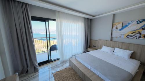 a bedroom with a bed and a large window at Xen Deluxe Boutique Hotel And Restaurant in Marmaris
