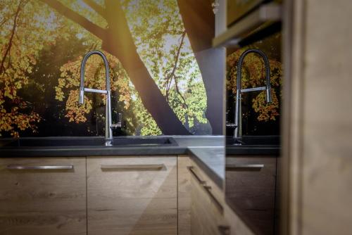 a kitchen with two sinks in front of a window at VillasDiNafplio - DIVA & PERLA in Nafplio