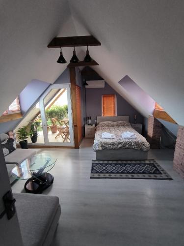 a bedroom with a bed in a attic at guest house Calma in Tʼelavi
