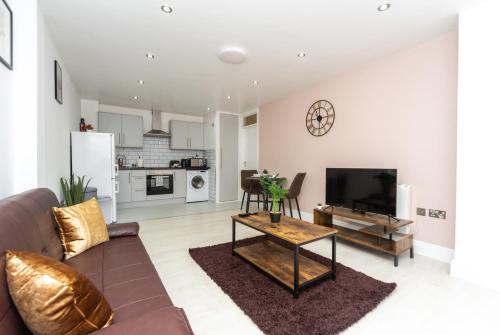 a living room with a couch and a tv at Modern One Bed Flat Lowestoft in Lowestoft