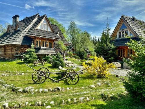 a house with a wagon in front of it at GORSKA OSADA Lovely Chalets Zakopane in Poronin