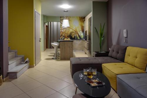 a living room with a couch and a table at VillasDiNafplio - DIVA & PERLA in Nafplio
