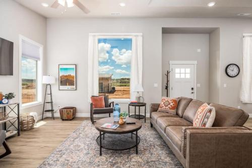 a living room with a couch and a table at High Desert luxury with views for families in Kanab
