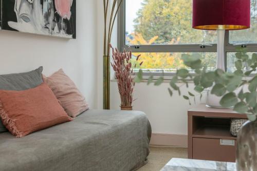 a living room with a couch and a window at The Luxury Inn in London